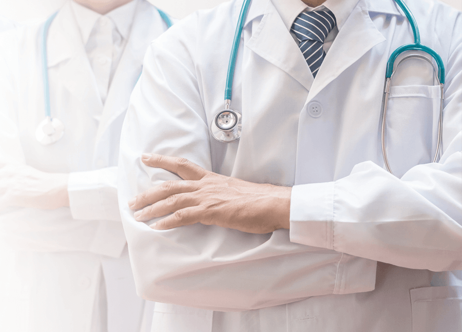 a close up of a physician with their arms crossed