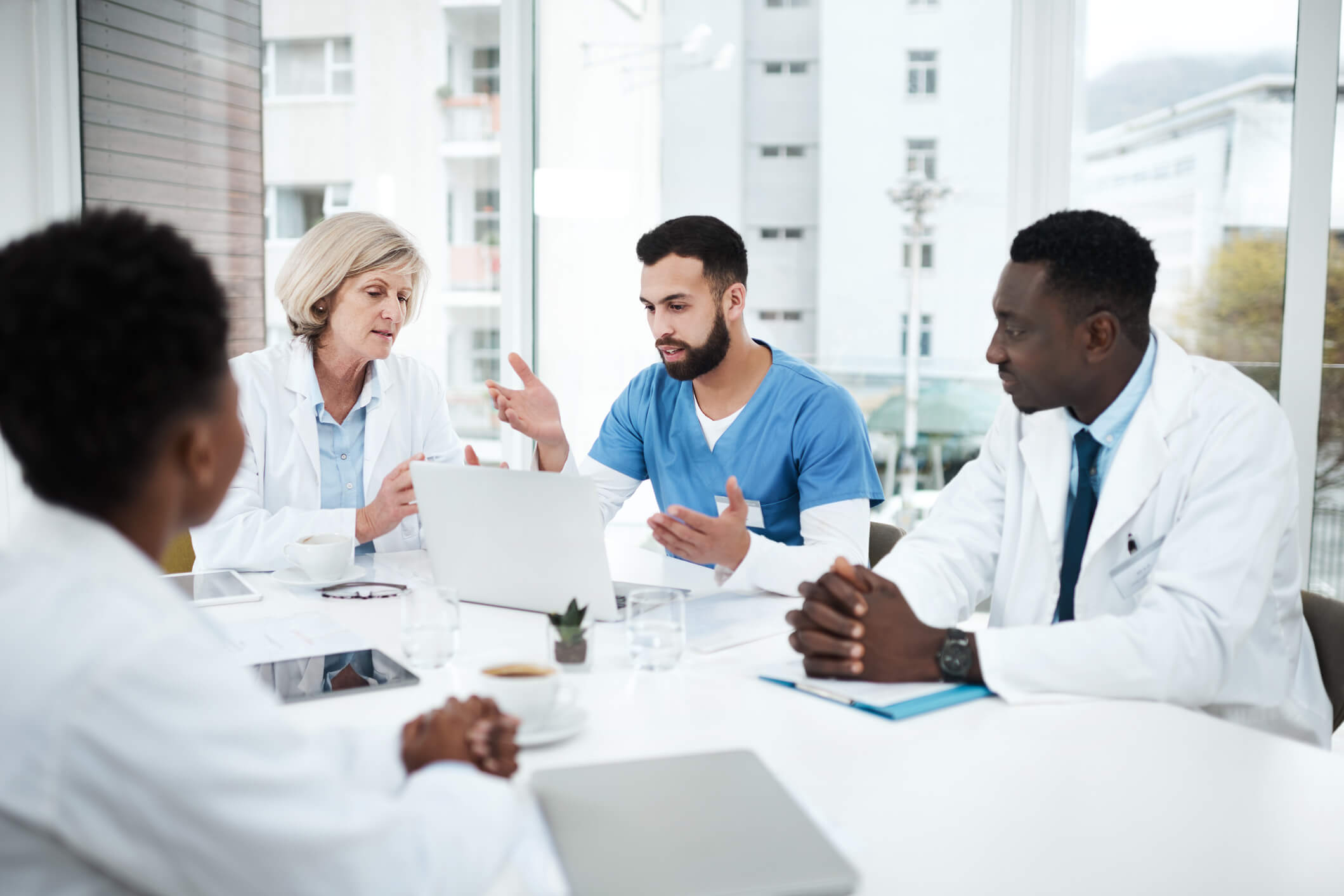 physicians in a meeting discussing treatment plans 