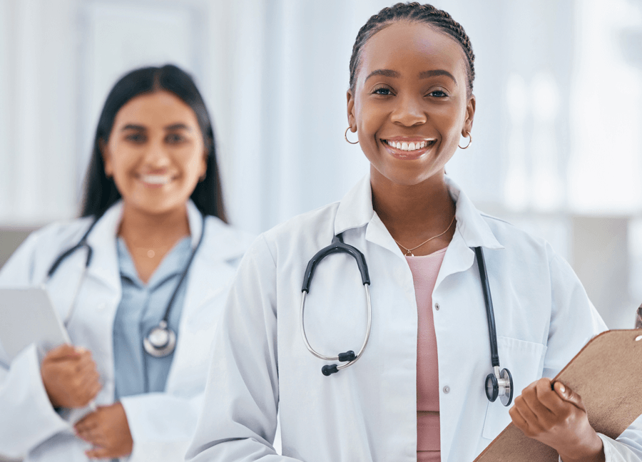 two female physicians smiling